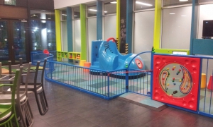 An indoor play area in a Dunedin cafe, featuring a blue boot slide