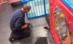 Our highly skilled engineer seen here installing the Playmatta Safety Tiles.