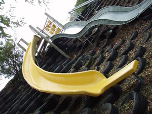 PLAYGEAR™ curved Fibreglass Slide and a Stainless Steel long Wavy Slide