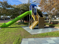 Tube slide tower with climbing wall